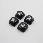 Vibrant electroplated aluminum cat paw arrow keycaps from different angles, highlighting their artistic metallic finish and premium quality.