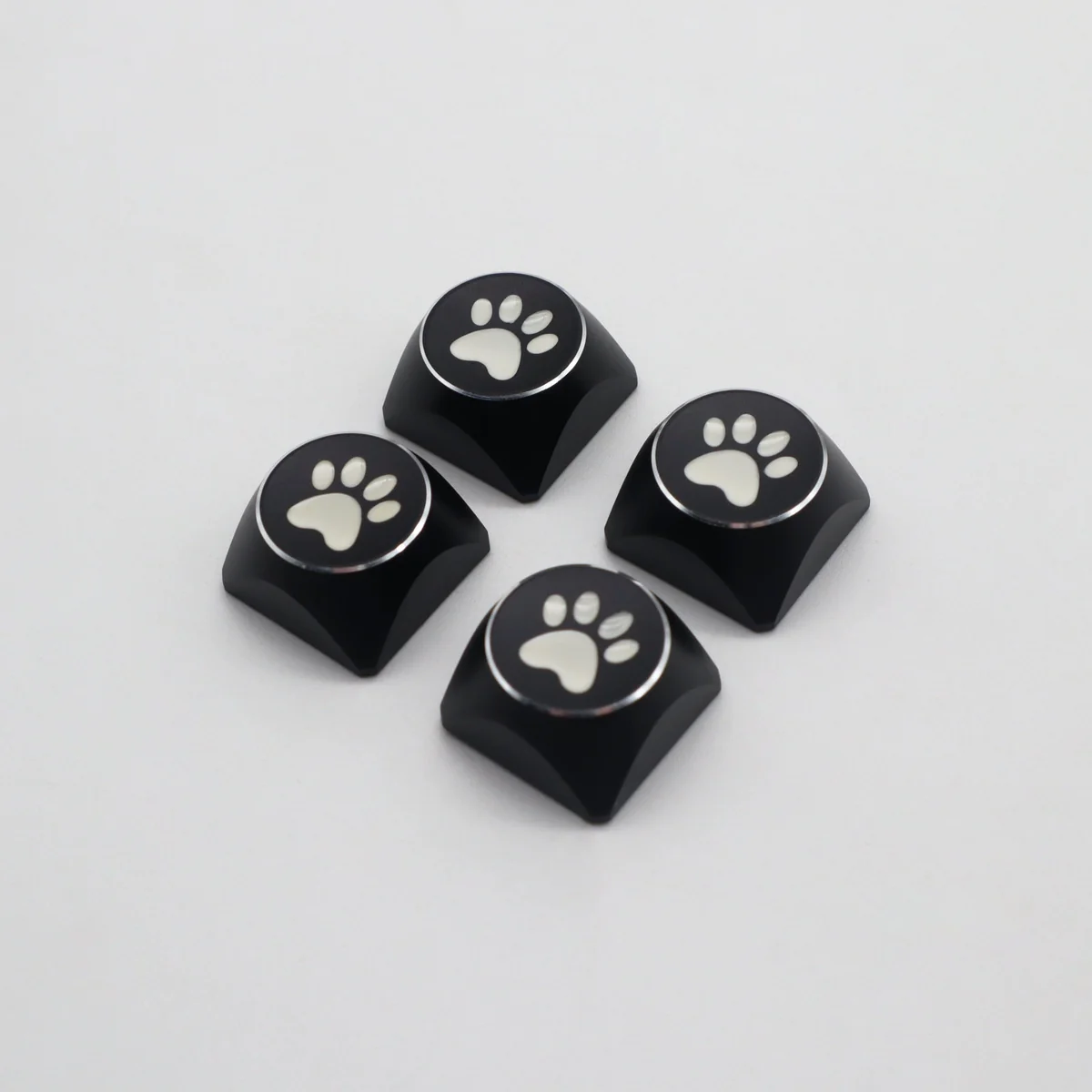 Vibrant electroplated aluminum cat paw arrow keycaps from different angles, highlighting their artistic metallic finish and premium quality.