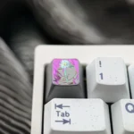 This image displays a stunning, hand-carved Titanium Chainsaw Man Reze artisan keycap from an engaging angle, revealing its dynamic character detail.