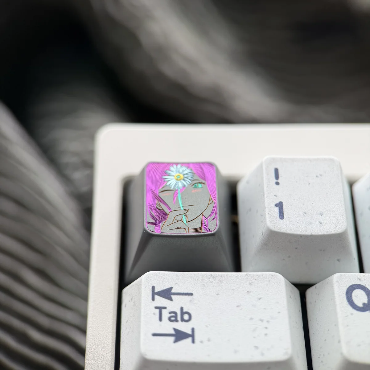 This image displays a stunning, hand-carved Titanium Chainsaw Man Reze artisan keycap from an engaging angle, revealing its dynamic character detail.