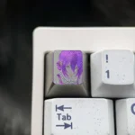 Hand-carved titanium Chainsaw Man Reze keycap, showcasing vibrant colored lines in Theme One, an artisan collectible.