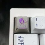 Chainsaw Man Reze hand-carved titanium keycap, Theme Three, showcasing vibrant colored lines on a metallic artisan collectible.