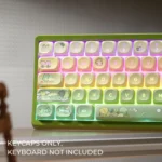 Whimsical frog MOA keycaps from a durable PBT double-shot set, showcasing clear backlit legends and the playful frog motif from various angles.