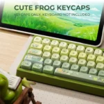 A gallery of whimsical Frog MOA Keycaps, showcasing their durable PBT double-shot construction and vibrant backlit legends from various playful angle.