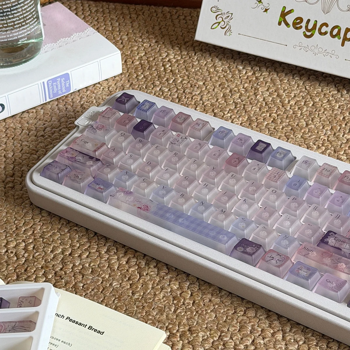Frosted floral keycaps in pastel purple and pink bring delicate floral illustrations and soft light to this full PC keycap set.