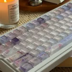 Frosted floral keycaps in pastel purple and pink cast delicate blossoms across this full PC keycap set.