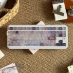 Frosted floral keycaps in pastel purple and pink create a dreamy full PC keycap set with delicate, soft-lit floral illustrations.