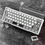 Multiple views of the 20th Anniv. Night Demon SE Gaming Keycap Set, featuring black and white special edition design and intricate details.