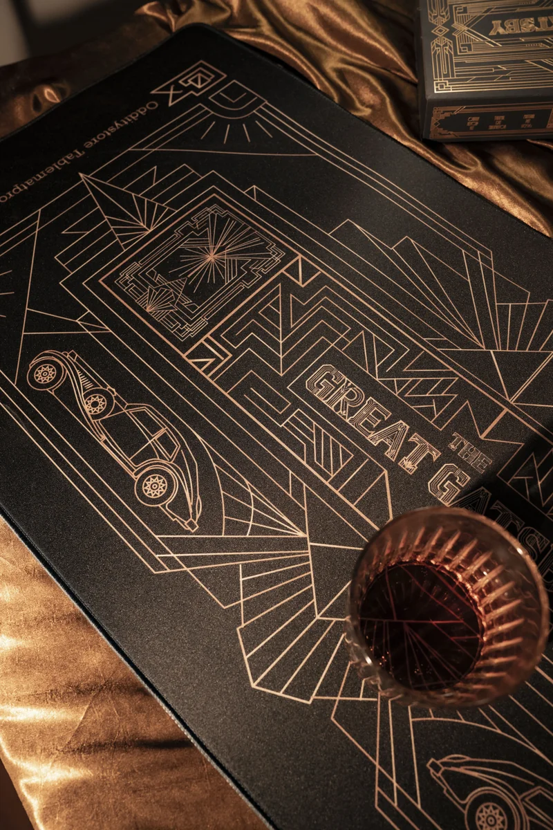 Angled shot of the luxurious Gatsby desk mat, featuring opulent golden Art Deco patterns, evoking 1920s elegance for a premium workspace.