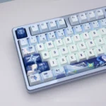 A collection of Genshin Impact Anastasya PBT translucent keycaps, showcased from multiple angles, highlighting their premium ethereal icy.