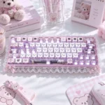 Pastel pink gloomy bear keycaps set with PBT side-engraved translucent keys, lace trim, hearts, and sweet desk accessories.