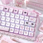 Pastel pink keyboard with translucent gloomy bear keycaps, PBT side-engraved details, lace ribbon, and sweet bear desk accessories.