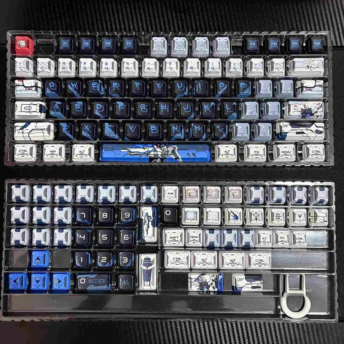 PBT Freedom Gundam mecha keycap from multiple angles, showcasing its dynamic futuristic design and intricate robotic details with glowing accents.