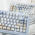 Detailed view of the whimsical dandelion fox hand-painted blue keycap set, showcasing exquisite artistry and dreamy blue hues from various angles.