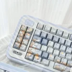 Hand-painted whimsical blue keycap set with dandelion and fox art, showcasing exquisite details and dreamy hues from multiple angles.