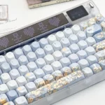 Artistic close-up of a hand-painted keycap set, revealing the intricate whimsical blue fox and dandelion motif, an exquisite piece of dreamy fantasy.