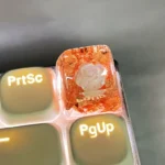 Handcrafted white 3D camellia artisan resin keycap featuring delicate silver foil accents, designed for SA profile keyboards.