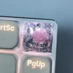 Exquisite handcrafted 3D white camellia artisan resin keycap, showcasing delicate blooms and shimmering rose gold foil.