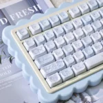 Adorable PBT MOA Healing Bear keycaps set, a close-up showing whimsical pastel bears and comforting elements, perfect for a joyful typing desktop aesthetics.