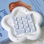 Close-up of an adorable pastel PBT MOA healing bear keycap, showcasing its whimsical design and smooth texture, part of the charming set for joyful typing.