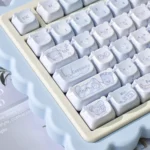 Adorable PBT MOA Healing Bear Keycaps set displayed from various angles, revealing charming pastel bear designs for a whimsical and joyful typing set.
