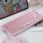 Frosted Pink full PC Hello Kitty keycap set on a pastel keyboard, with glossy candy-like translucent keys and cute motifs in a playful setup.