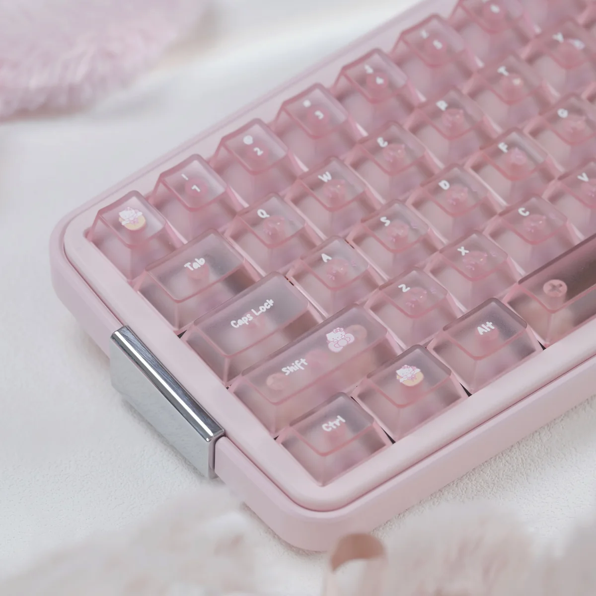 Close-up of Frosted Pink PC Hello Kitty keycaps, a full set with glossy candy-like finish and playful motifs on a pastel keyboard.