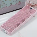 Hello Kitty keycaps in a Frosted Pink PC full keycap set with glossy candy-like keys and cute motifs on a pastel keyboard.