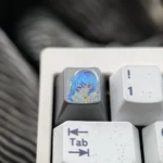 Hand-carved Hoshimachi Suisei titanium keycap from an artistic angle, revealing intricate lines and vibrant anime character details on premium alloy.