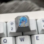 Close-up of the intricately hand-carved Hoshimachi Suisei titanium VTuber keycap, showcasing the vibrant anime character design and fine details.