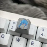 Close-up of the hand-carved Hoshimachi Suisei titanium VTuber keycap, showcasing its vibrant anime design and intricate lines from a unique angle.