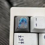 A stunning hand-carved titanium Hoshimachi Suisei keycap, showcasing vibrant anime detail and intricate lines, perfect for VTuber fans.