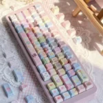 Jewelpet keycaps 130-key PBT pastel translucent set with side-lit animal legends on a pink keyboard and scattered kawaii keycaps.
