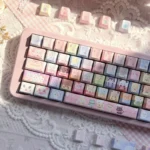 Playful Jewelpet keycaps on a pink keyboard feature pastel rainbow animal characters and translucent side-lit legends across this 130-key PBT set.