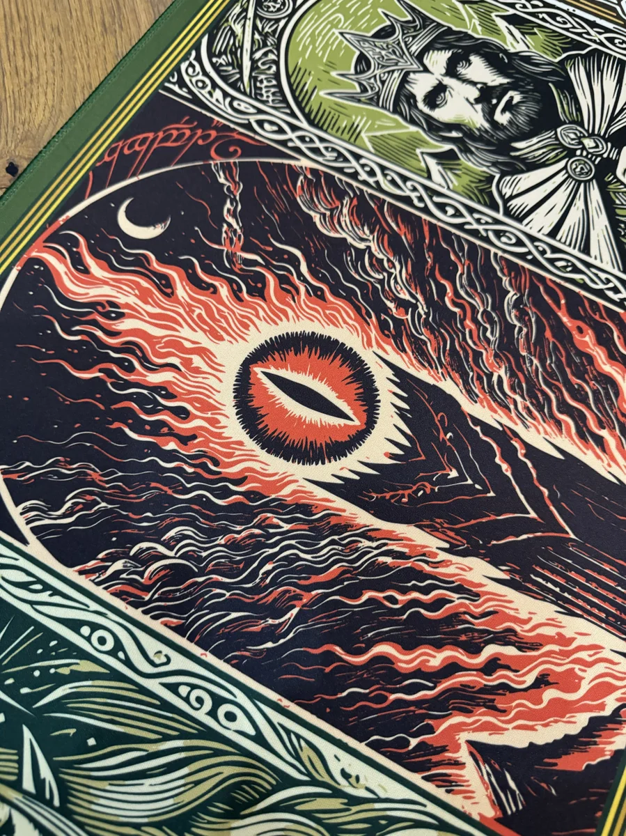 Artistic close-up of the Lord Rings Desk Mat, showcasing a detailed section of the authentic Middle-earth map and vibrant fantasy landscapes.