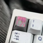 Hand-carved titanium Makima artisan keycap, shown from a unique angle. Highlights intricate line art and dark metallic finish.