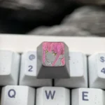 Artistic hand-carved titanium Makima artisan keycap, revealing intricate Chainsaw Man line art and a dark metallic finish from a distinct angle.