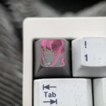 Hand-carved titanium Makima artisan keycap, showcasing intricate Chainsaw Man character details with a dark, artistic metallic finish on a keyboard.