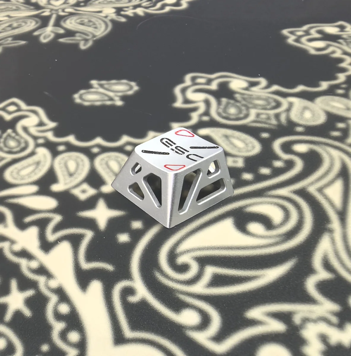 R4 Esc Silver Metal Hollow Keycap with intricate artisan design. Displays a premium feel and modern, high-tech hollow patterns.