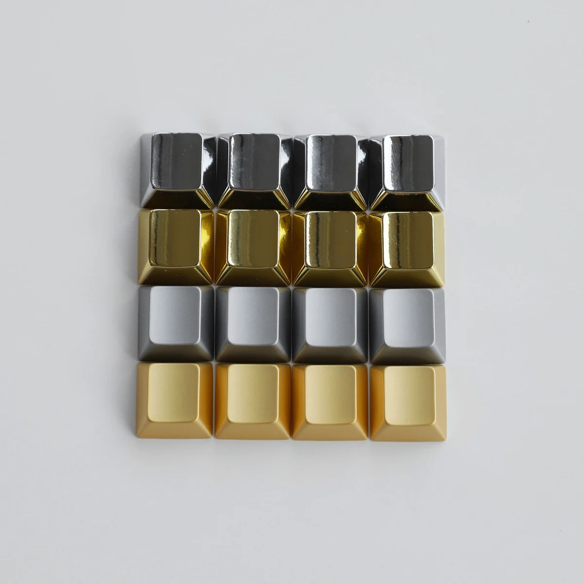 Premium blank zinc alloy R1 directional metal keycap, showcasing its sleek, unadorned design and high-quality metallic finish from all angles.