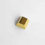 Close-up of a premium blank R1 directional metal keycap, showcasing its sleek zinc alloy finish and modern industrial-chic aesthetic.