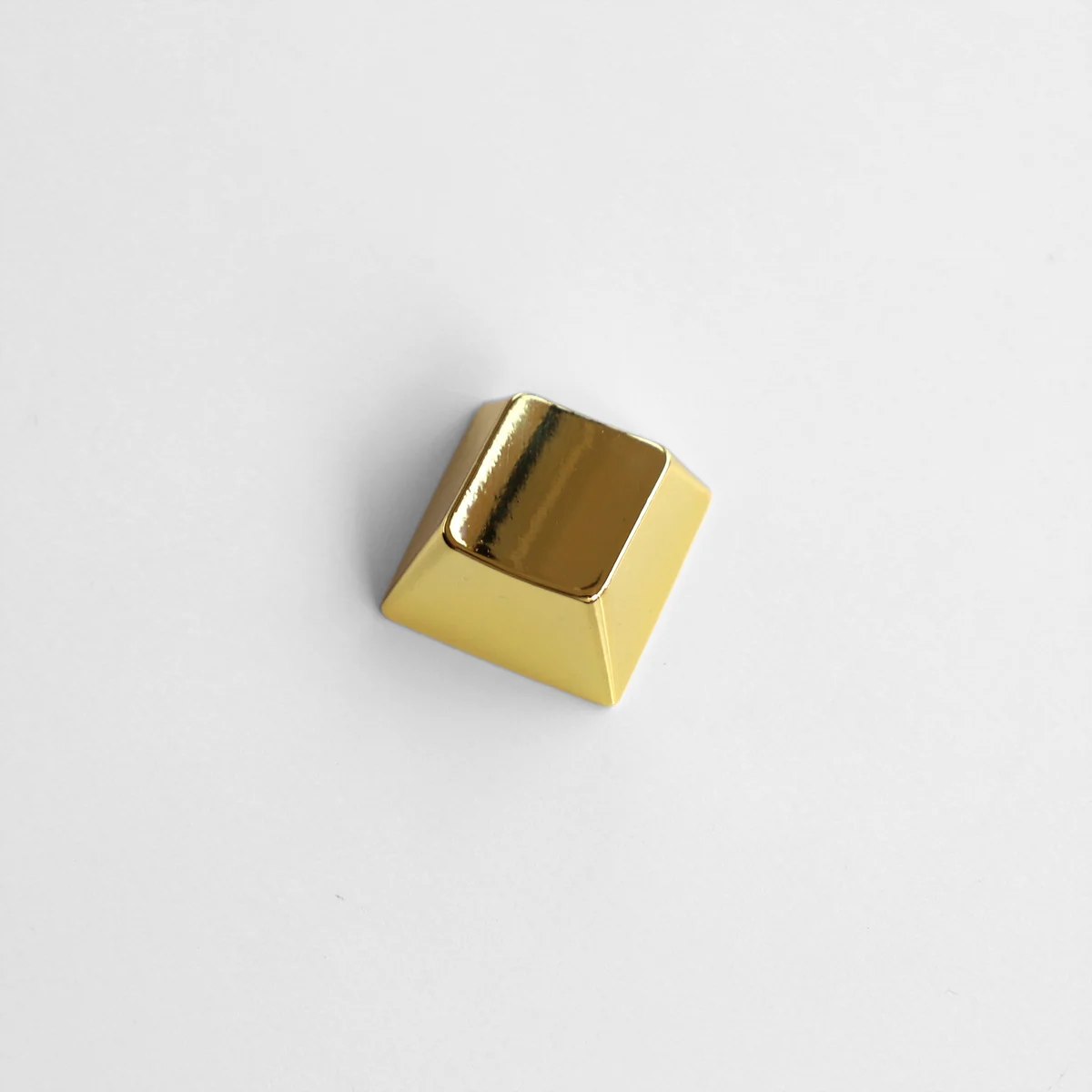 Close-up of a premium blank R1 directional metal keycap, showcasing its sleek zinc alloy finish and modern industrial-chic aesthetic.