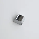 Close-up gallery of a premium blank zinc alloy R1 directional metal keycap, showcasing its sleek, modern industrial-chic finish from multiple angles。