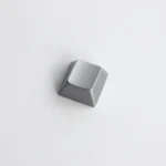 Gallery of premium blank zinc alloy R1 directional metal keycaps, highlighting their sleek, modern industrial-chic design from multiple angles.