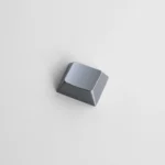 Showcasing a premium zinc alloy R1 1.25u blank metal keycap from multiple angles, emphasizing its sleek metallic finish and minimalist design.