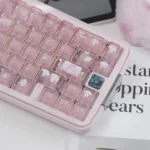 Close-up of My Melody keycaps in frosted pastel pink with cute bow, paw, and character details on a pink mechanical keyboard.