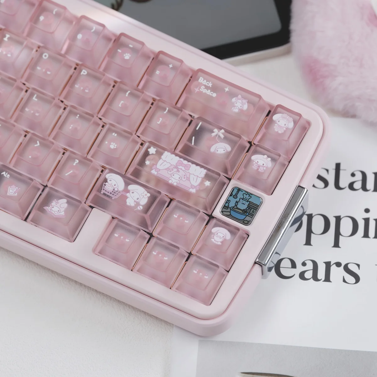 Close-up of My Melody keycaps in frosted pastel pink with cute bow, paw, and character details on a pink mechanical keyboard.