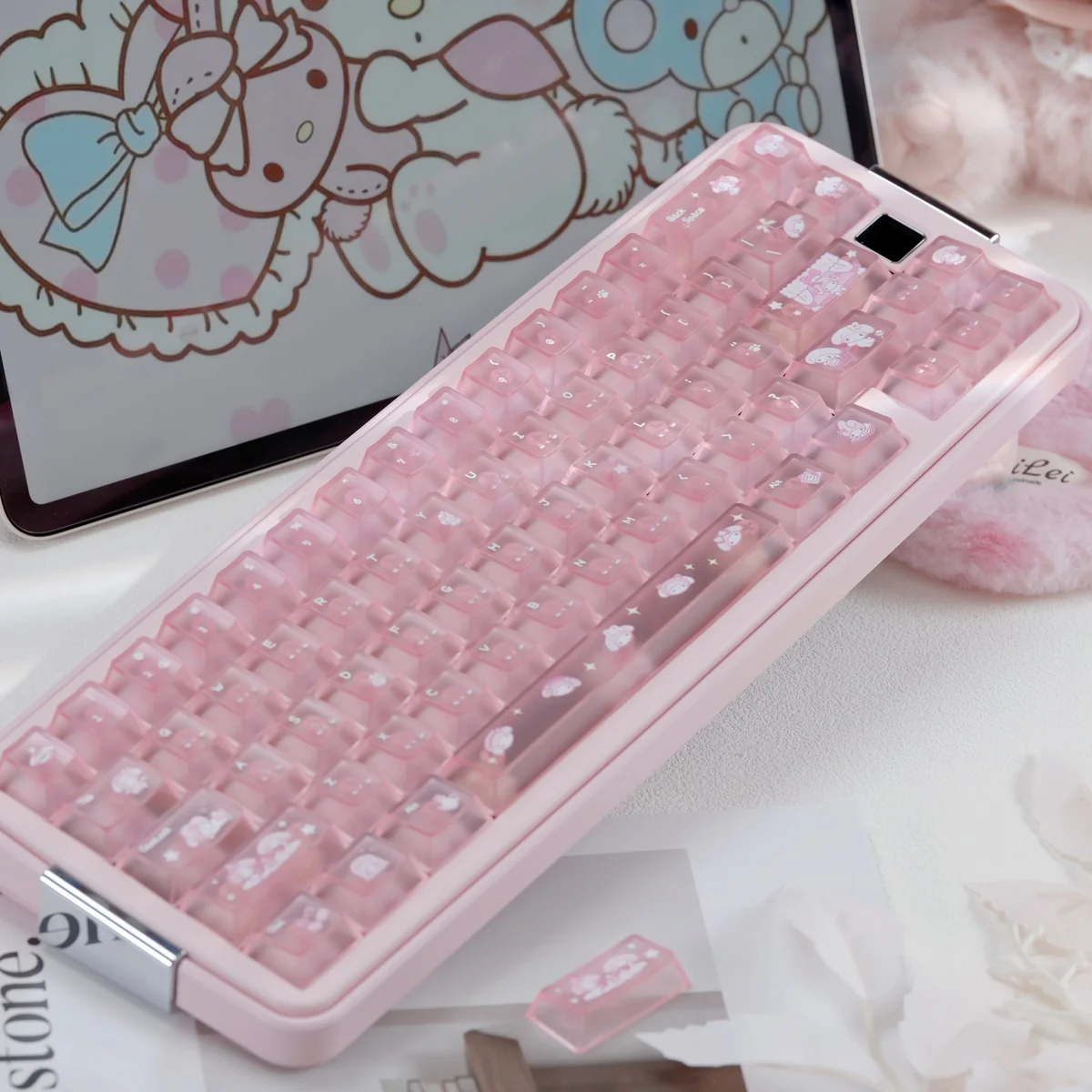 My Melody keycaps set with frosted pastel pink PC, adorable bow and paw prints, and character illustrations on a playful keyboard.