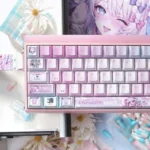 Close-up of the exclusive Needy Streamer Overload 3.0 PBT keycap set, showcasing vibrant KAngel anime art and a pearlescent finish from multiple angles.