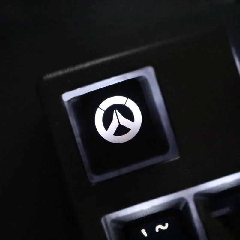 Multiple views of the translucent Overwatch R4 gaming keycap, highlighting its vibrant glow and iconic design from various angles.